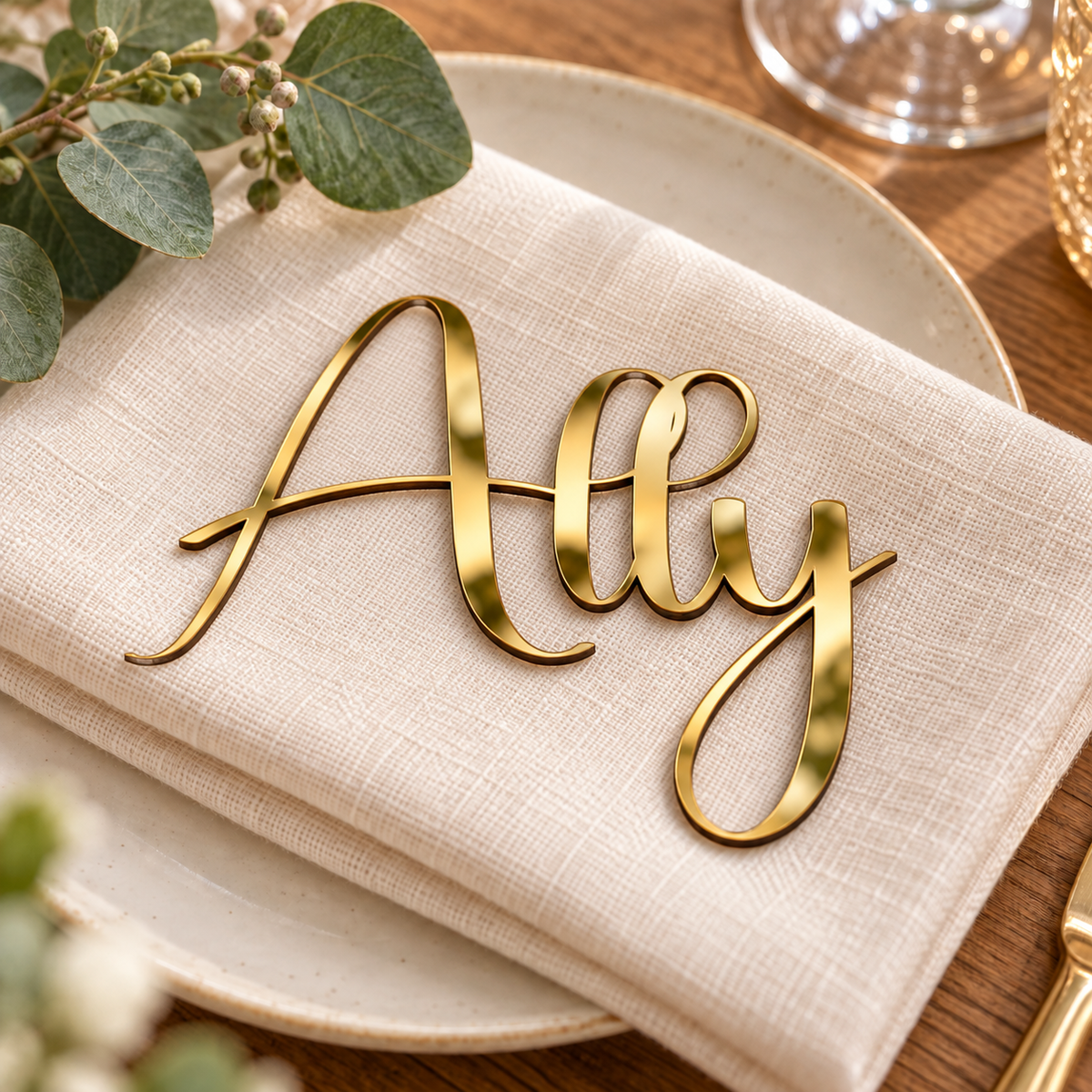 Ally in Bridger font, Mirror Gold Acrylic personalised guest name on an ivory napkin.