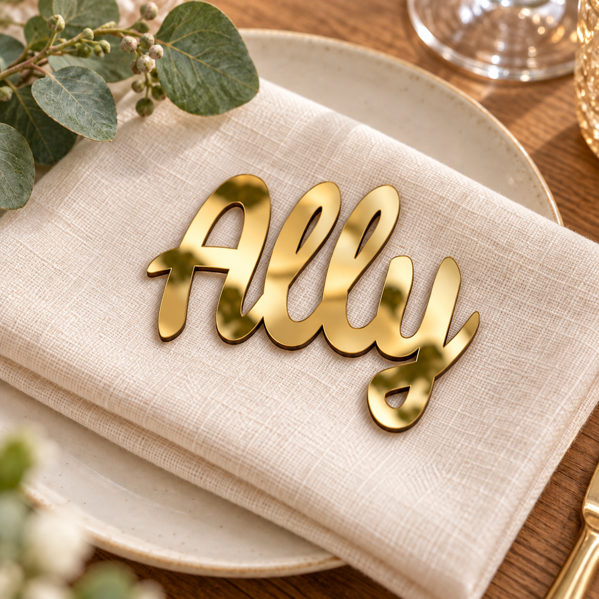Ally in Ramla font, Mirror Gold Acrylic personalised guest name on an ivory napkin.