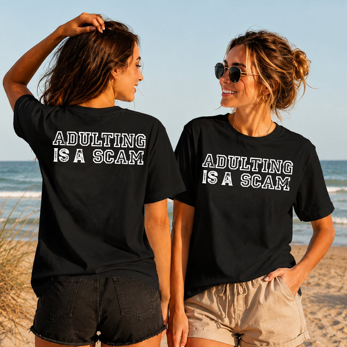 Adulting Is a Scam - Women's T-Shirt in black, showing alternative back and front print placements on the beach