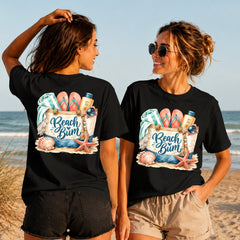 Beach Bum - Women's T-Shirt in black, showing alternative back and front print placements on the beach