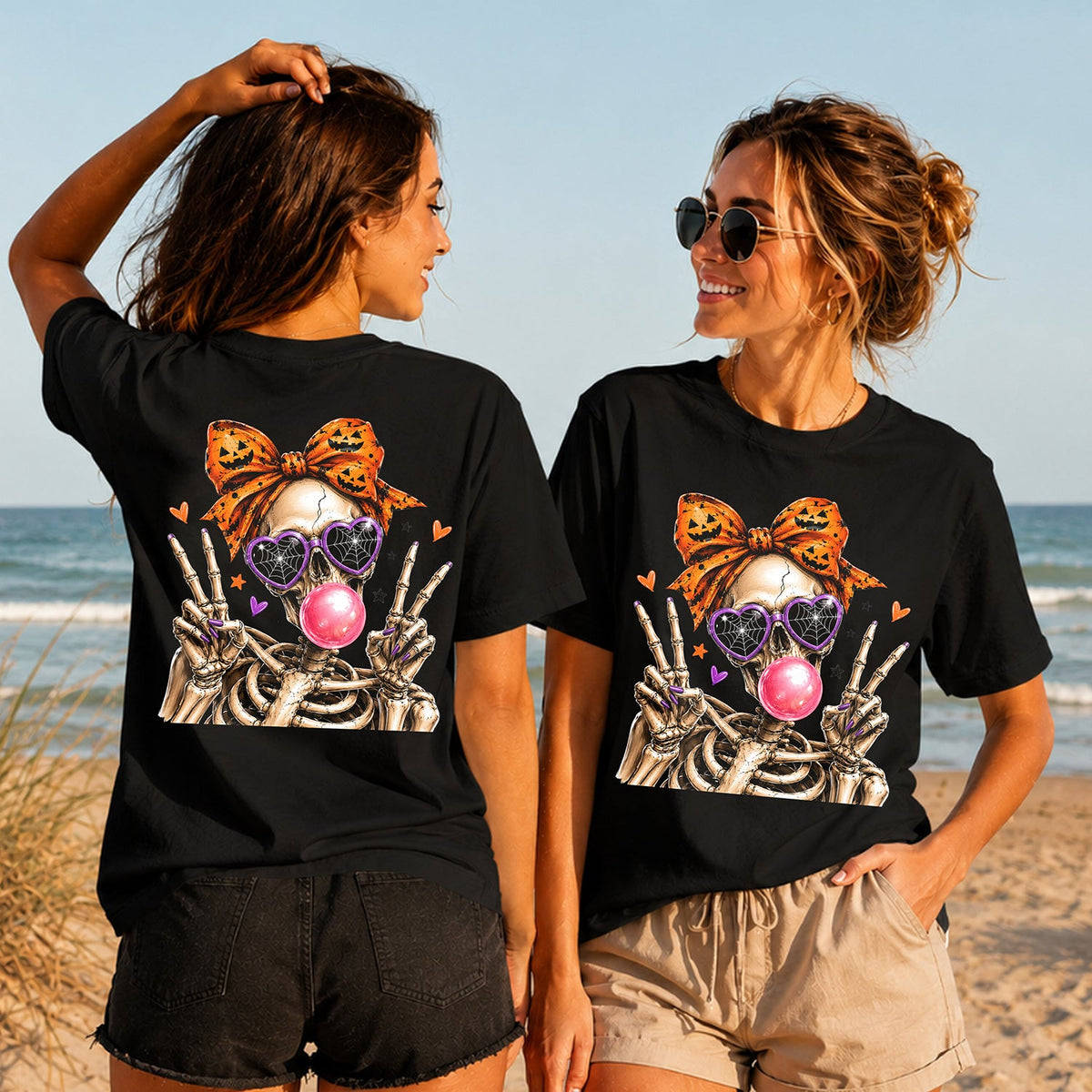 Bubblegum Skeleton - Women's T-Shirt in black, showing alternative back and front print placements on the beach