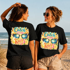 Catch Some Rays - Women's T-Shirt in black, showing alternative back and front print placements on the beach