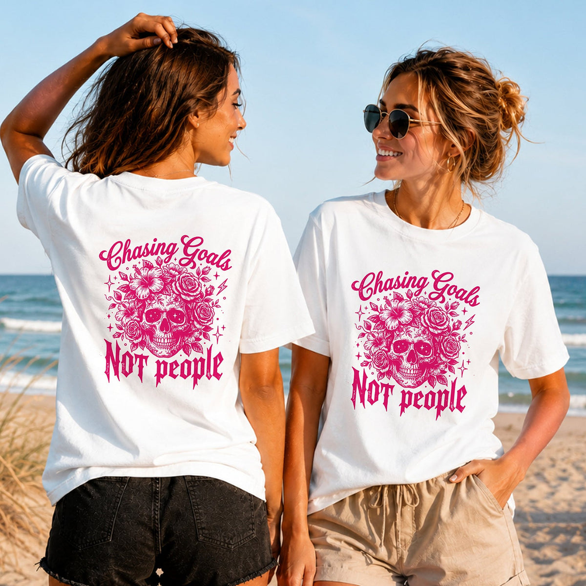 Chasing Goals - Pink Skull - Women's T-Shirt in white, showing alternative back and front print placements on the beach