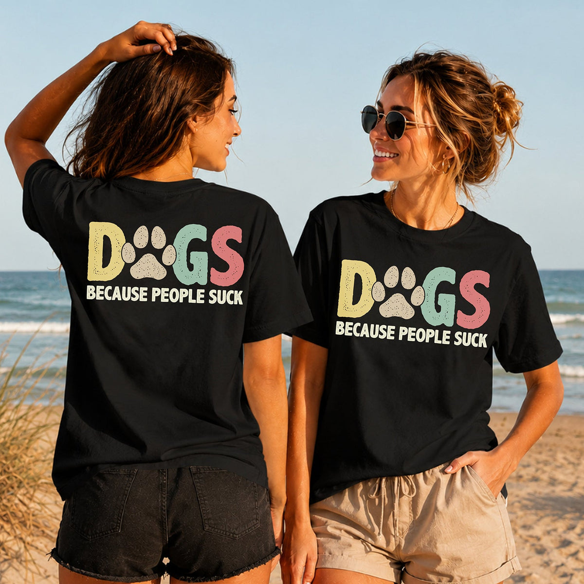 Dogs Because People Suck - Women's T-Shirt in black, showing alternative back and front print placements on the beach