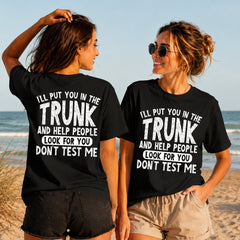 Don't Test Me - Trunk Club - Women's T-Shirt in black, showing alternative back and front print placements on the beach