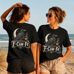 F-Caw-Fe Raven - Women's T-Shirt in black, showing alternative back and front print placements on the beach