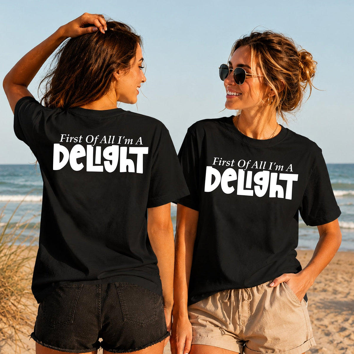 First of All I'm a Delight - Women's T-Shirt in black, showing alternative back and front print placements on the beach