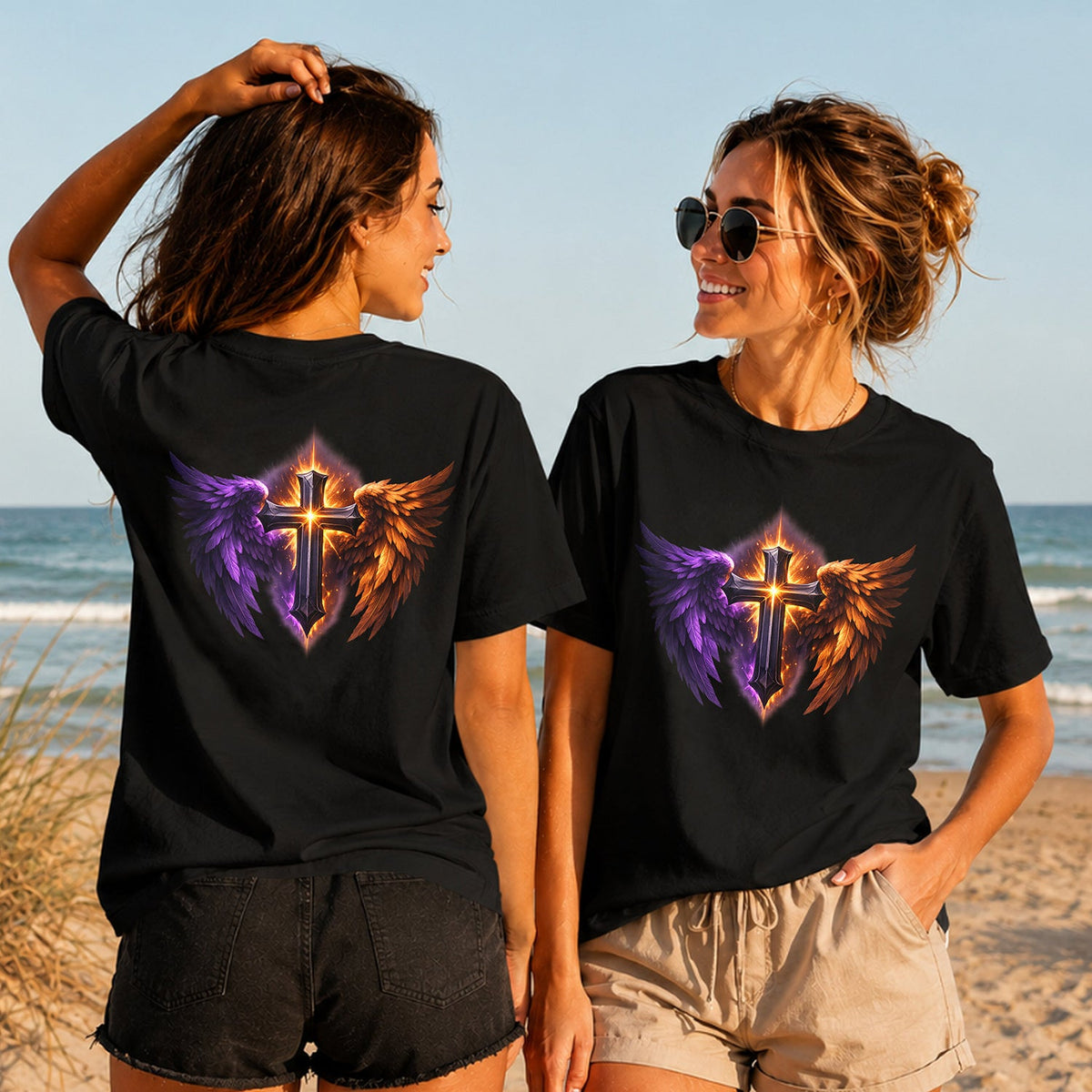Flame and Shadow Cross - Women's T-Shirt in black, showing alternative back and front print placements on the beach