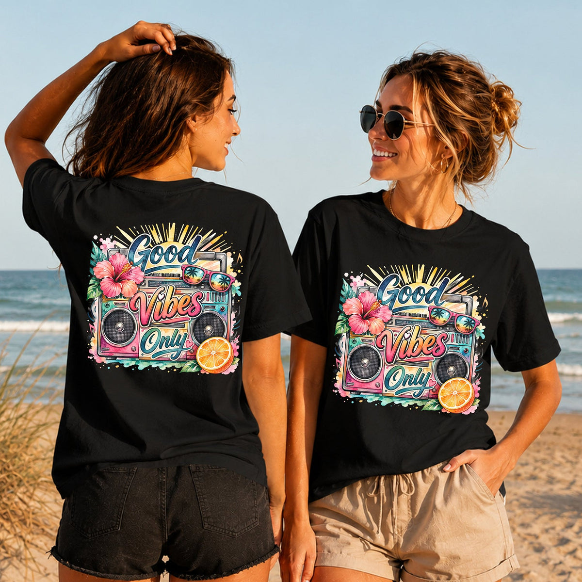 Good Vibes Only Boombox - Women's T-Shirt in black, showing alternative back and front print placements on the beach