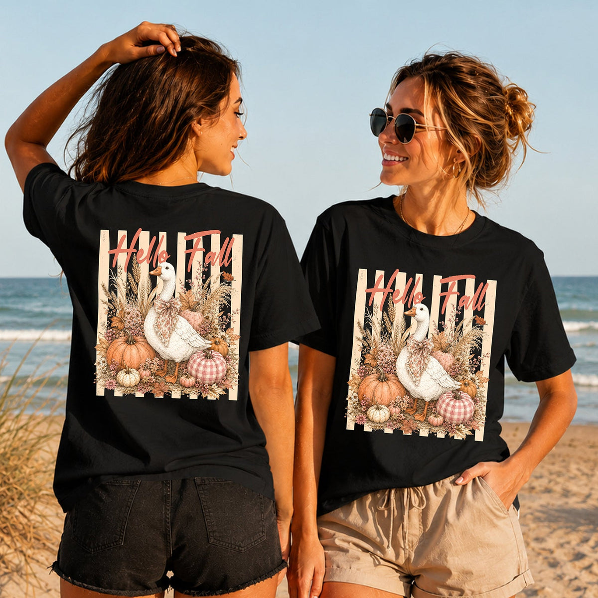 Hello Fall Goose - Women's T-Shirt in black, showing alternative back and front print placements on the beach