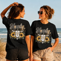 Howdy Sunflower Skull - Women's T-Shirt in black, showing alternative back and front print placements on the beach