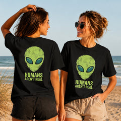 Humans Aren't Real - Women's T-Shirt in black, showing alternative back and front print placements on the beach