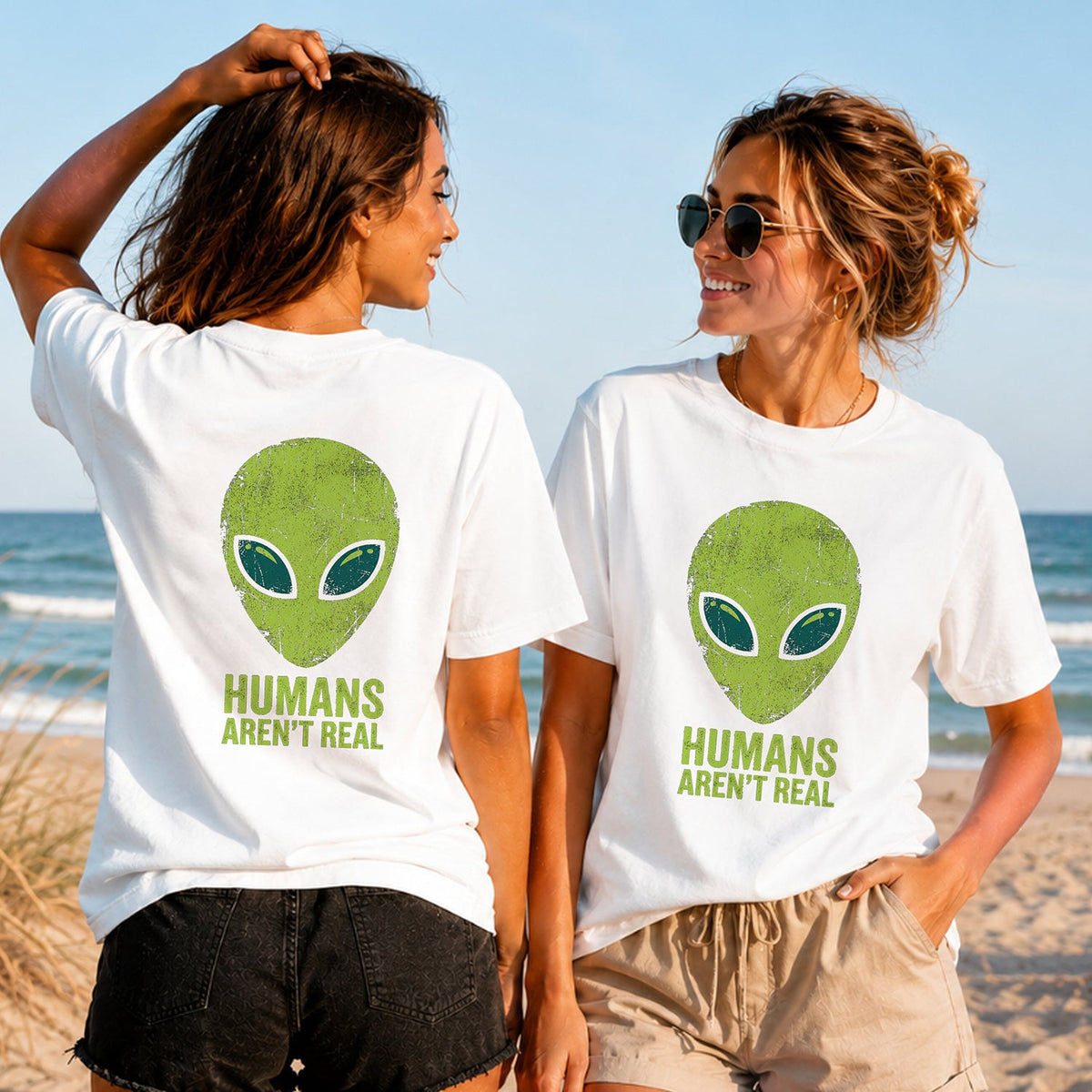 Humans Aren't Real - Women's T-Shirt in white, showing alternative back and front print placements on the beach