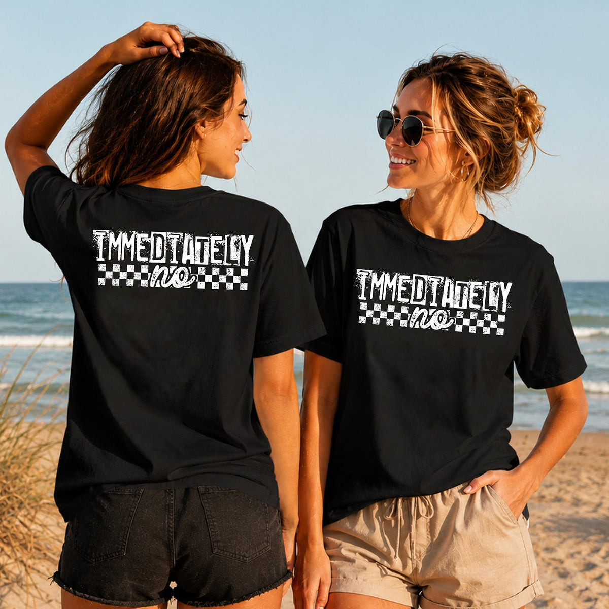 Immediately No - Women's T-Shirt in black, showing alternative back and front print placements on the beach