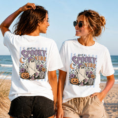 Just a Spooky Vibe - Women's T-Shirt in white, showing alternative back and front print placements on the beach
