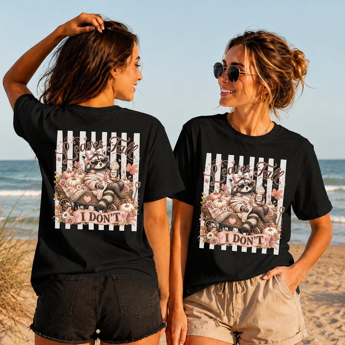 Leaves Fall I Don't - Glam Raccoon - Women's T-Shirt in black, showing alternative back and front print placements on the beach