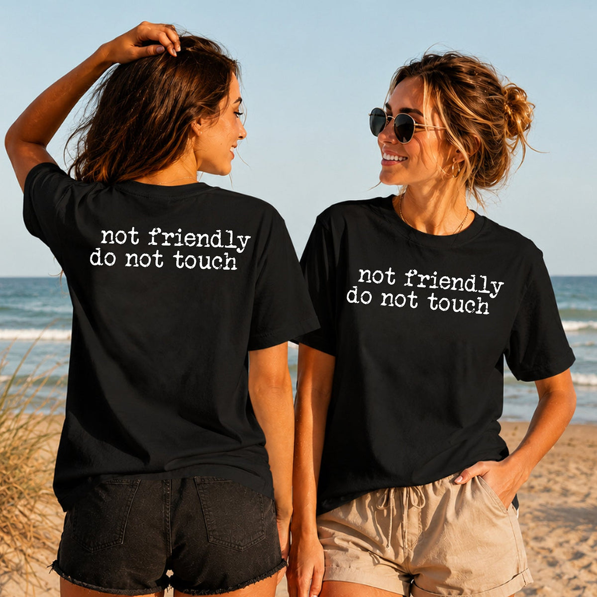 Not Friendly Do Not Touch - Women's T-Shirt in black, showing alternative back and front print placements on the beach