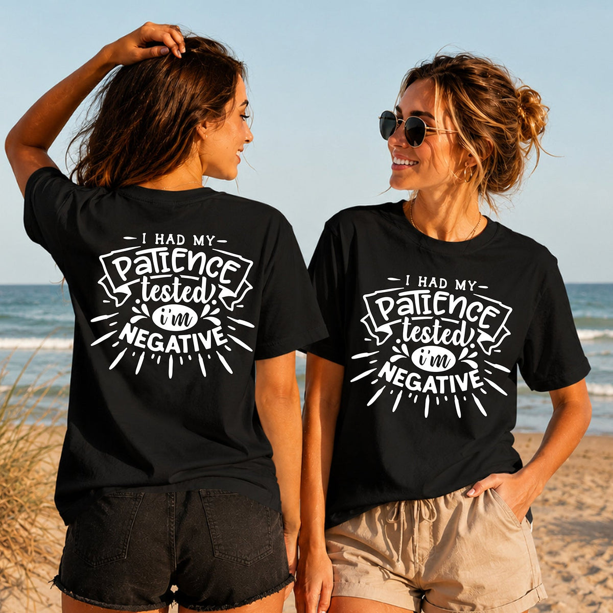 Patience Tested Negative - White - Women's T-Shirt in black, showing alternative back and front print placements on the beach