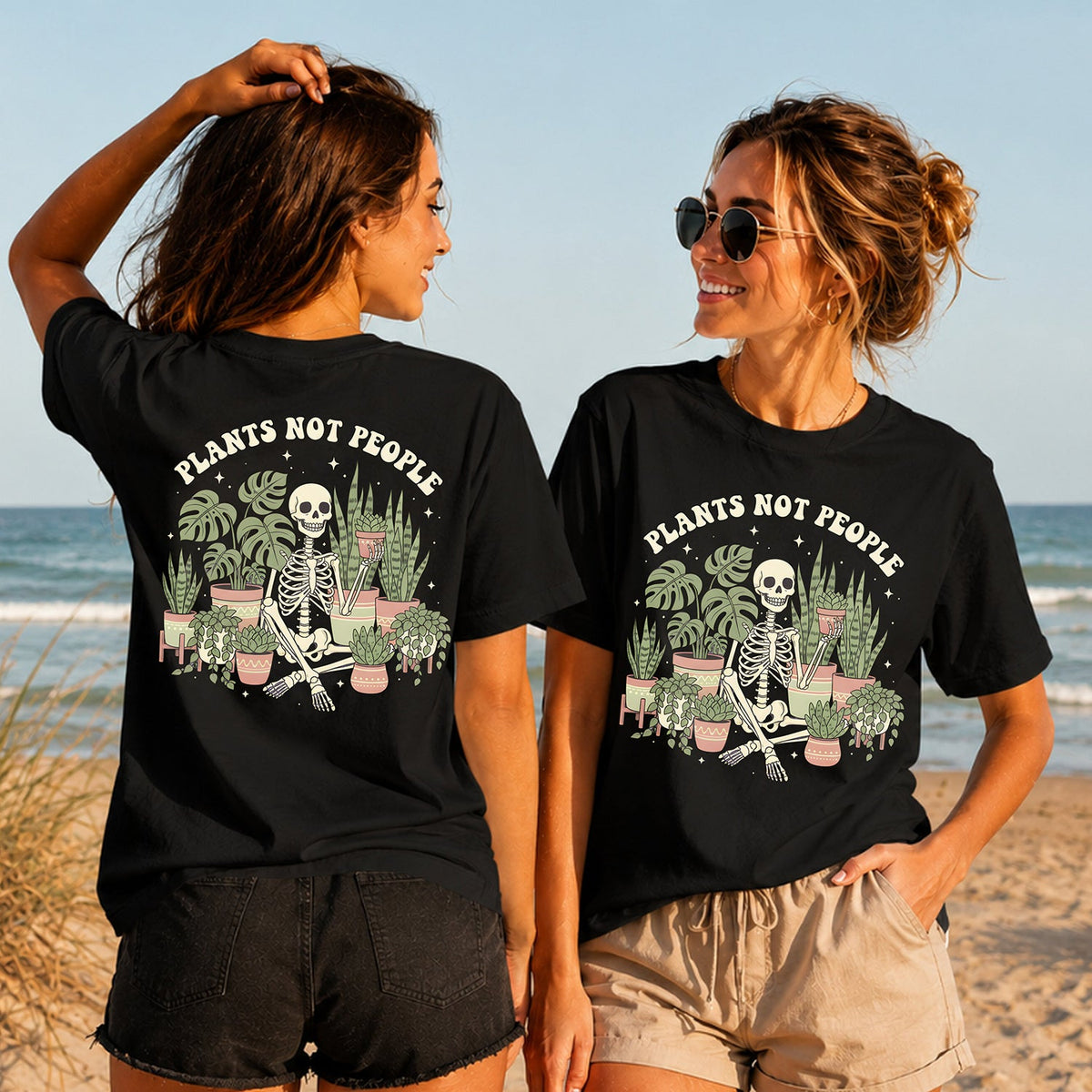 Plants Not People - Women's T-Shirt in black, showing alternative back and front print placements on the beach