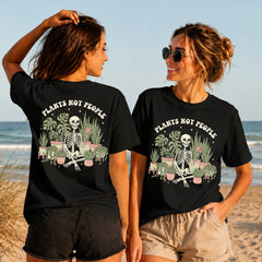 Plants Not People - Women's T-Shirt in black, showing alternative back and front print placements on the beach