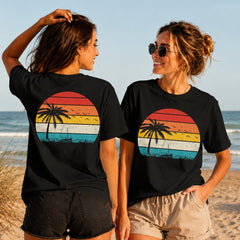Retro Summer Sunset - Women's T-Shirt in black, showing alternative back and front print placements on the beach