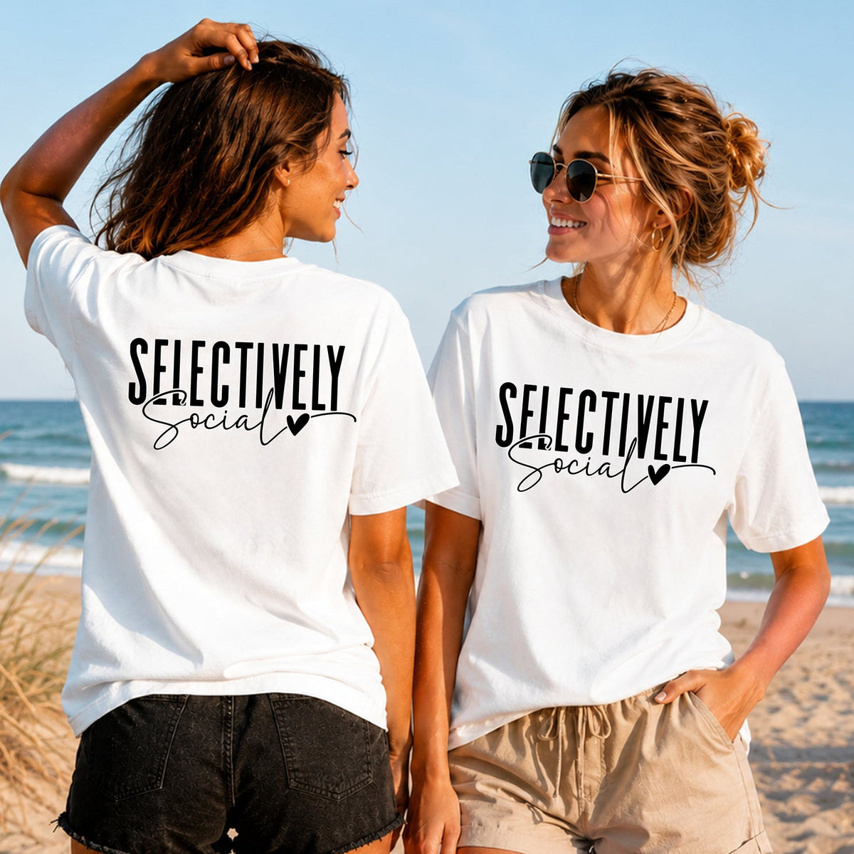 Selectively Social - Black Script - Women's T-Shirt in white, showing alternative back and front print placements on the beach