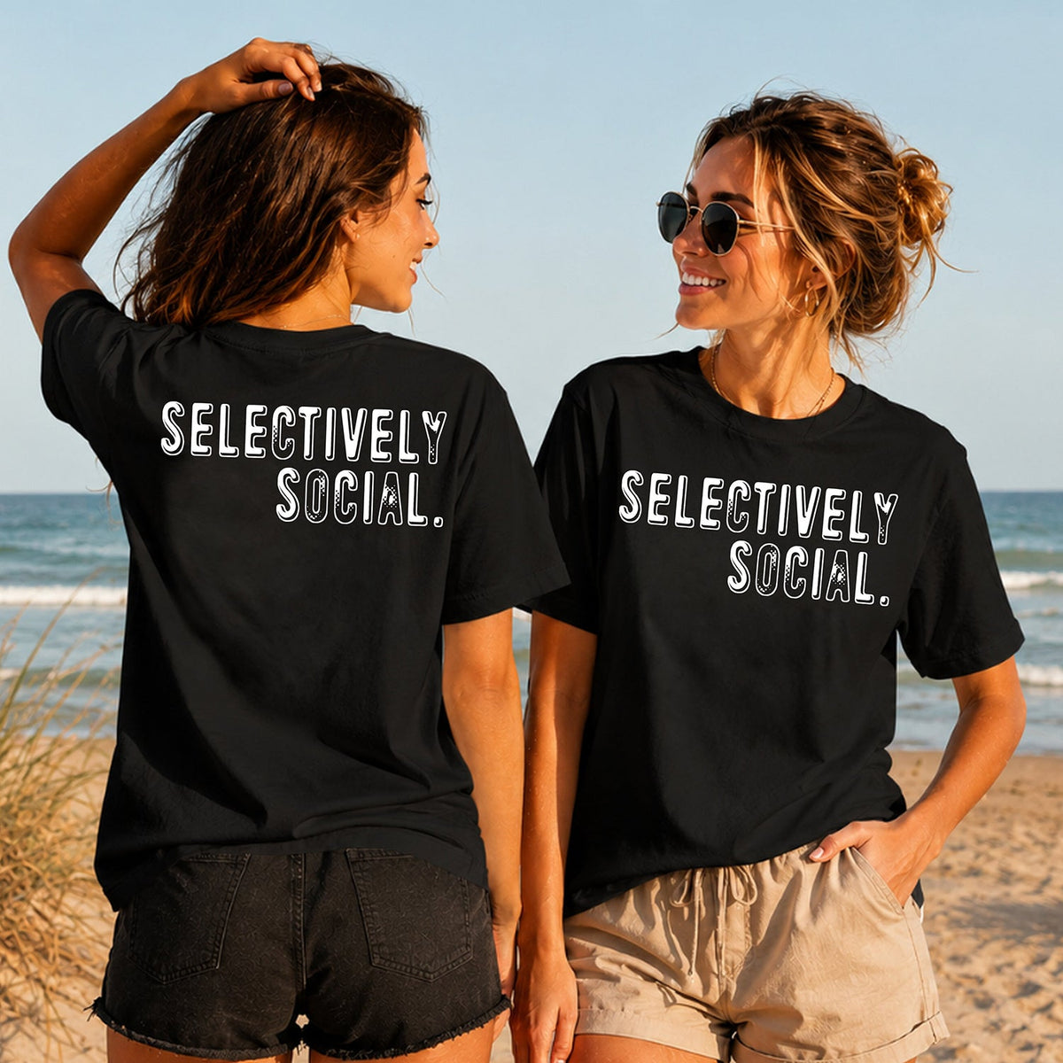 Selectively Social - White Varsity - Women's T-Shirt in black, showing alternative back and front print placements on the beach