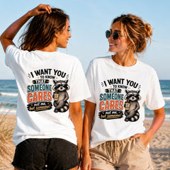Someone Cares Not Me - Women's T-Shirt in white, showing alternative back and front print placements on the beach