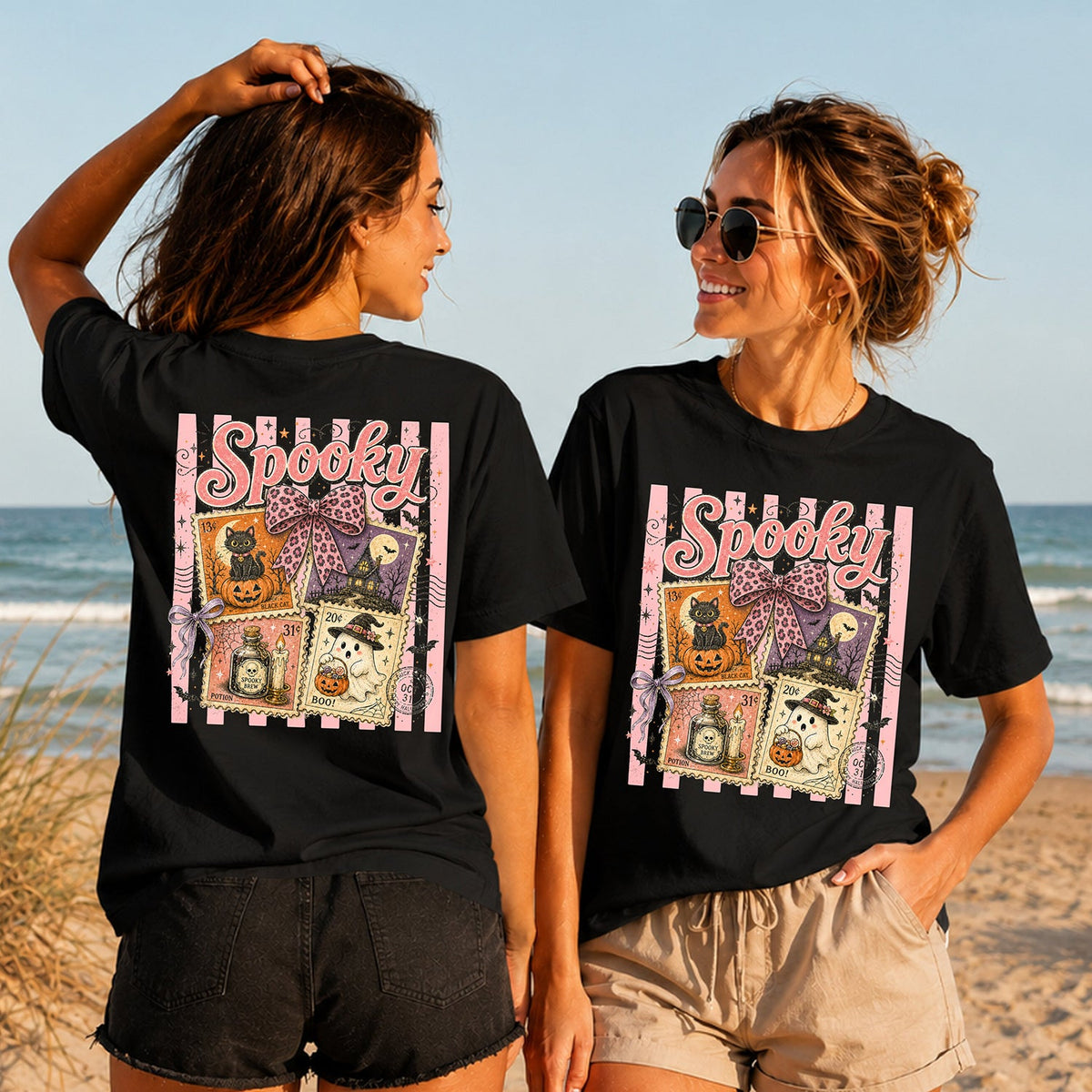 Spooky Postage - Women's T-Shirt in black, showing alternative back and front print placements on the beach