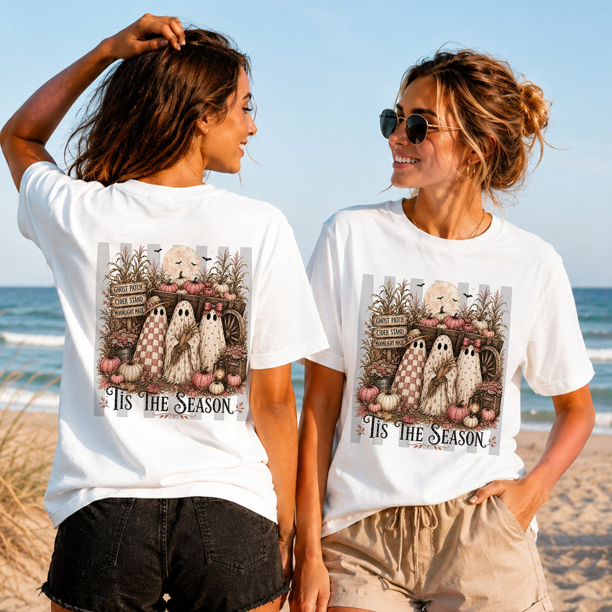 Tis the Season Ghost Market - Women's T-Shirt in white, showing alternative back and front print placements on the beach