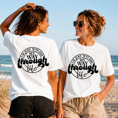 WTF-ing Through Life - Black - Women's T-Shirt in white, showing alternative back and front print placements on the beach