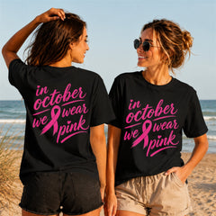 We Wear Pink Cursive Quote 2 - Women's T-Shirt in black, showing front and back print placement choices