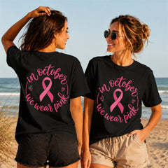 We Wear Pink Cursive Quote 3 - Women's T-Shirt in black, showing front and back print placement choices