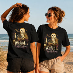 Wicked Wisdom Owl - Women's T-Shirt in black, showing alternative back and front print placements on the beach