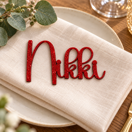 Nikki in Bridger font, Bright Red Glitter Acrylic personalised guest name on an ivory napkin.