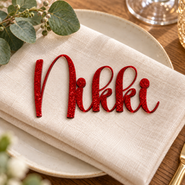 Nikki in Bubble font, Bright Red Glitter Acrylic personalised guest name on an ivory napkin.