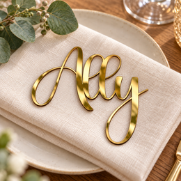 Ally in Bubble font, Mirror Gold Acrylic personalised guest name on an ivory napkin.