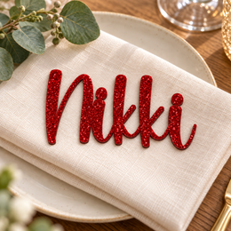 Nikki in Caylin font, Bright Red Glitter Acrylic personalised guest name on an ivory napkin.