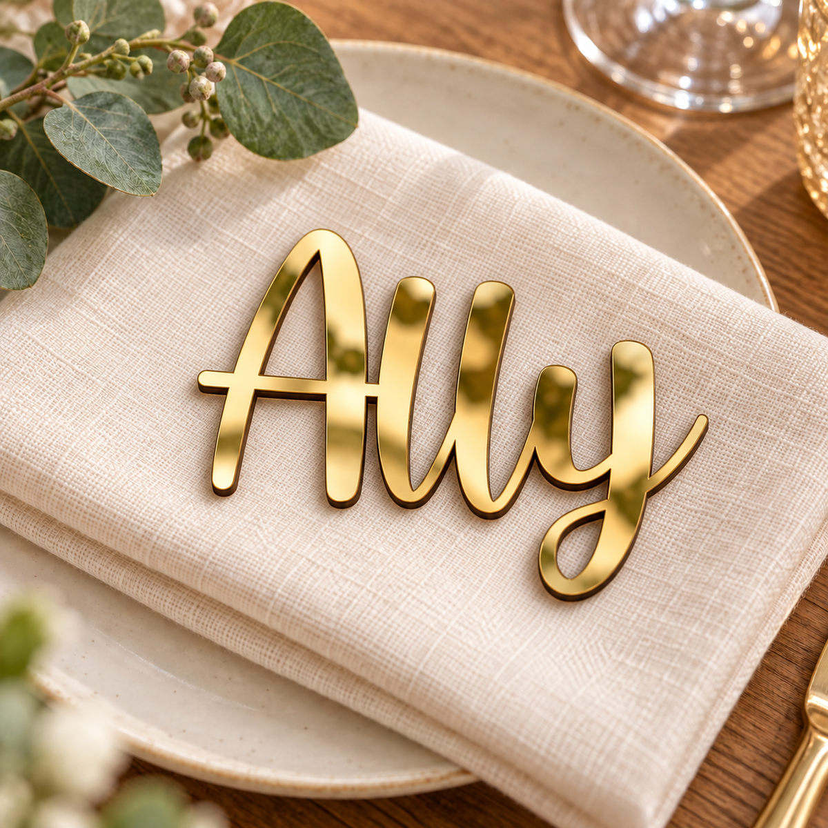 Ally in Caylin font, Mirror Gold Acrylic personalised guest name on an ivory napkin.