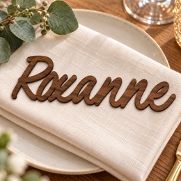 Roxanne in Caylin font, Walnut Varnished Plywood personalised guest name on an ivory napkin.
