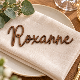 Roxanne in Framhouse font, Walnut Varnished Plywood personalised guest name on an ivory napkin.