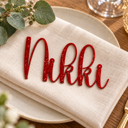 Nikki in Highbright font, Bright Red Glitter Acrylic personalised guest name on an ivory napkin.