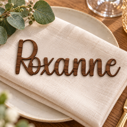 Roxanne in Ladybug font, Walnut Varnished Plywood personalised guest name on an ivory napkin.