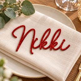 Nikki in Monaline font, Bright Red Glitter Acrylic personalised guest name on an ivory napkin.