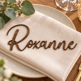 Roxanne in Potography font, Walnut Varnished Plywood personalised guest name on an ivory napkin.