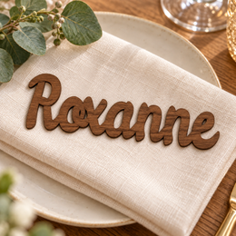 Roxanne in Ramla font, Walnut Varnished Plywood personalised guest name on an ivory napkin.
