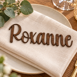 Roxanne in Writing Monogram font, Walnut Varnished Plywood personalised guest name on an ivory napkin.